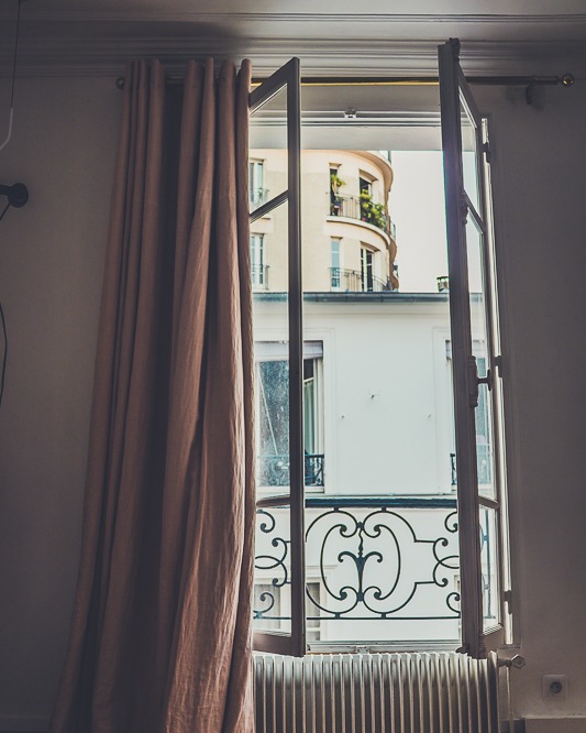 The art of noticing is a practice. 
It’s the little things that make a moment unforgettable.
The open window, the curtain leaning just so, the design etched into the building across the way, the hum of Paris waking outside.
For me, this view held even more. It was the morning of our 20th anniversary — the dream I had whispered for years: to wake up in Paris with my husband on that day. And here it was. 
Simple, beautiful, unforgettable.